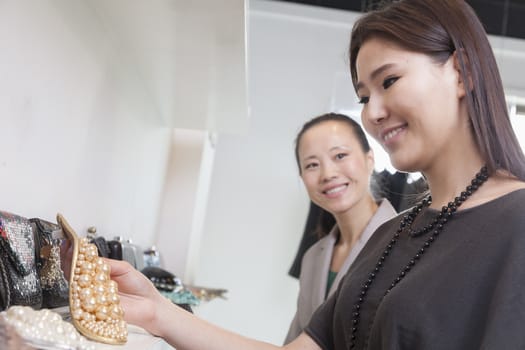 Young woman shopping for accessories at store