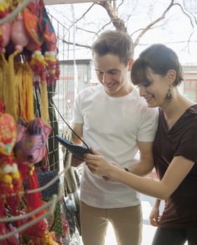 Young couple looking at souvenirs.