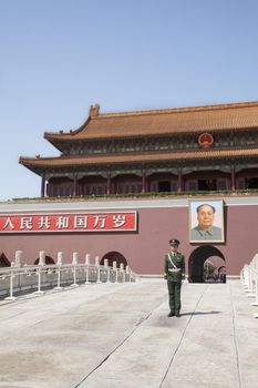 Tiananmen Square, Gate of Heavenly Peace with Mao's Portrait and guard, Beijing, China.