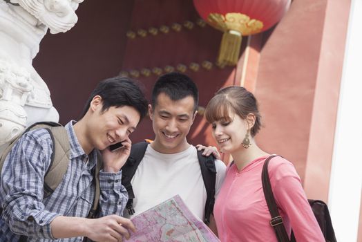 Three people looking at map.  
