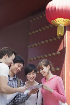 Four people looking at map.