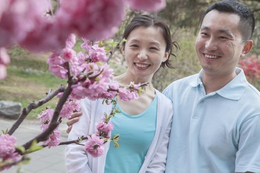 Couple looking at cherry blossoms.