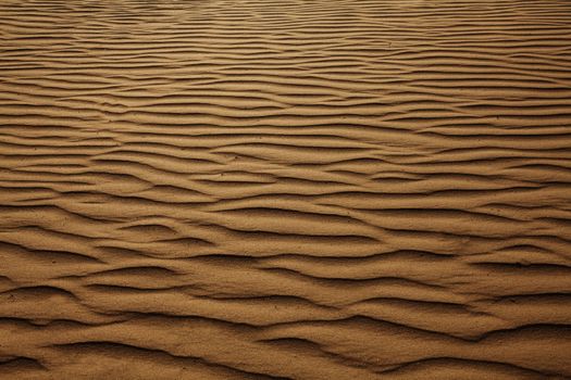 Texture background of wind pattern on sand dunes, full frame