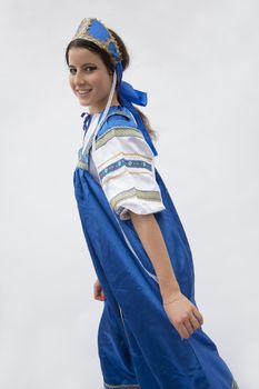 Portrait of young smiling  woman in traditional clothing from Russia, studio shot