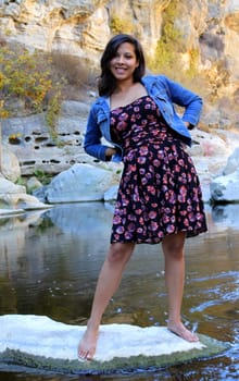 Young Hispanic woman near a creek.