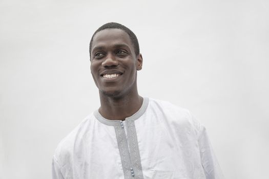 Portrait of young man in traditional African clothing, studio shot