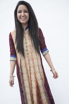 Portrait of smiling young woman wearing traditional clothing from Pakistan, studio shot