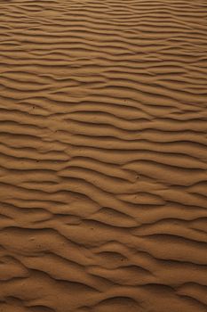 Texture background of wind pattern on sand dunes, full frame