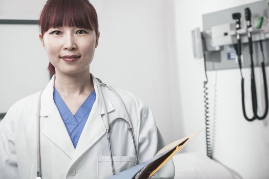 Portrait of smiling female doctor holding a clipboard