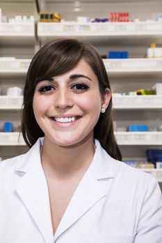 Portrait of smiling young pharmacist looking at the camera in a pharmacy