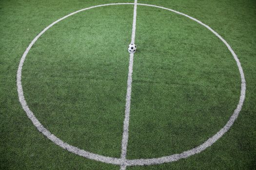Soccer field with soccer ball on the line, high angle view