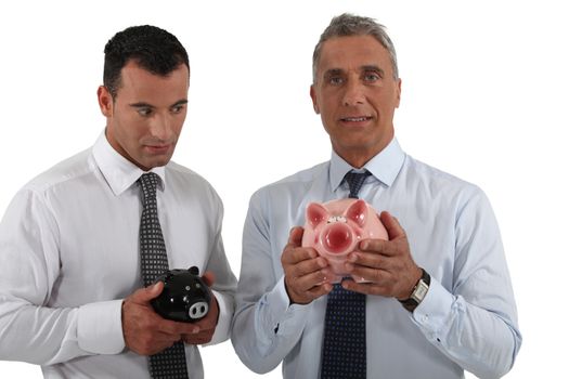 Two businessmen stood with piggy bank