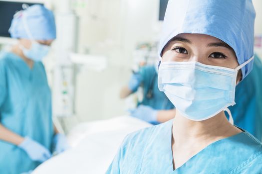 Portrait of female surgeon wearing surgical mask in the operating room, close-up