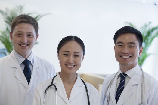 Portrait of three smiling doctors in the hospital, multi-ethnic group