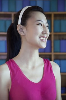 Portrait of young woman smiling in a yoga studio