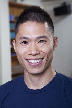 Portrait of smiling man in a yoga studio, head and shoulders
