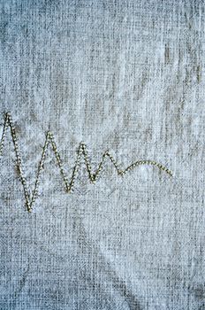 linen shirt background with thread embroider ornament background closeup.