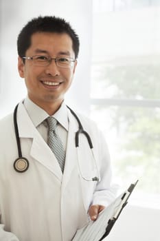 Portrait of smiling doctor with a stethoscope and medical chart