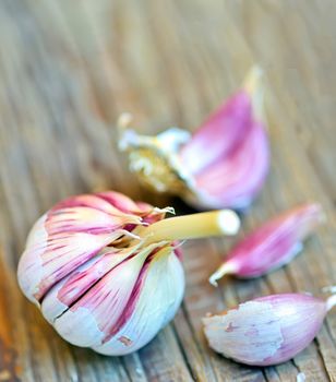garlic bulb and clove of garlic on old wood 