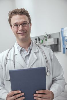 Portrait of smiling doctor holding a clipboard