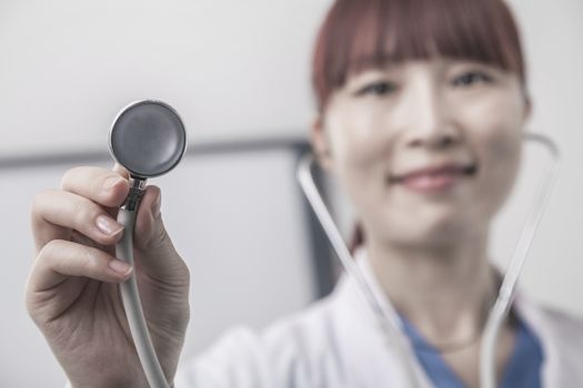 Portrait of female doctor holding a stethoscope, Close-Up