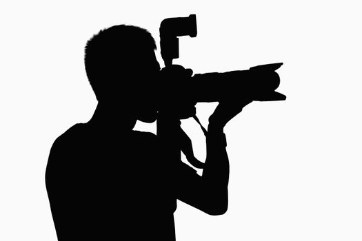 Silhouette of man holding camera.