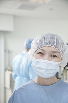 Portrait of surgeon with surgical mask and surgical cap in the operating room 