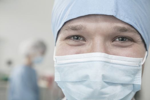 Portrait of surgeon with surgical mask and surgical cap in the operating room 