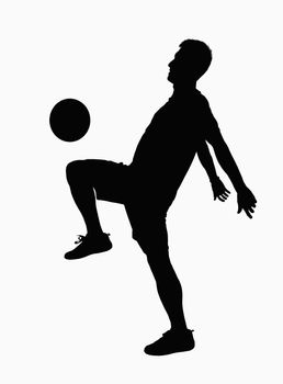 Silhouette of soccer player practicing juggling the ball. 