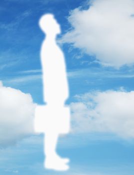 Silhouette of businessman holding a briefcase with a blue sky and clouds behind him