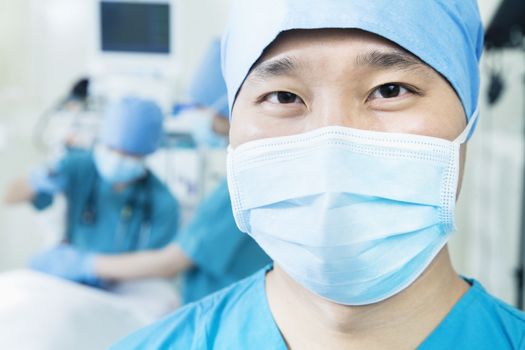 Portrait of surgeon wearing surgical mask in the operating room, close-up