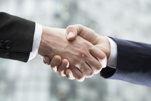 Close-up of two businessmen shaking hands