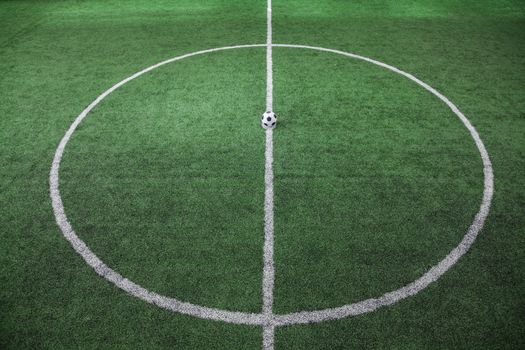 Soccer field with soccer ball on the line, high angle view