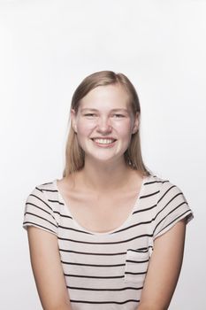 Portrait of teenage girl with blond hair smiling, studio shot