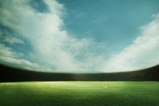 Digital coposit of soccer field and blue sky