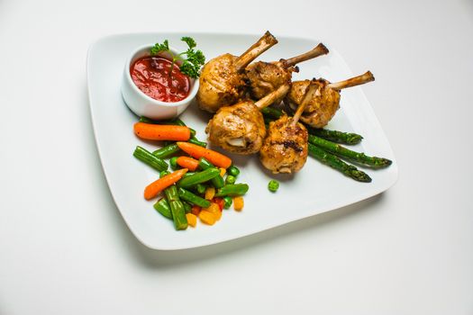 chicken legs with asparagus, lettuce and ketchup