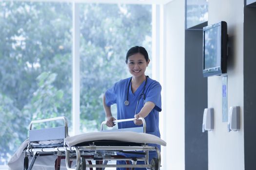 Nurse wheeling empty stretcher in the halls of the hospital