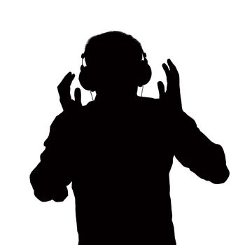 Silhouette of man listening to headphones. 