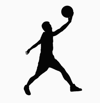 Silhouette of basketball player jumping with ball.