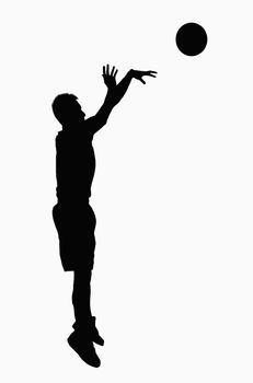 Silhouette of basketball player jumping.