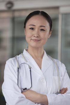 Portrait of female doctor with arms crossed outside of the hospital