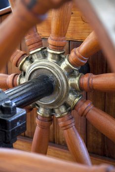 Old wooden steering wheel of the ship 
