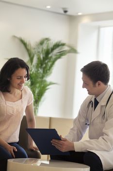 Doctor and patient sitting down and discussing medical record in the hospital