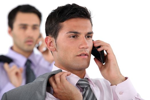 businessmen talking on their cell phone
