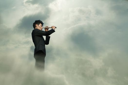 Young businessman looking through telescope in a dreamlike cloud
