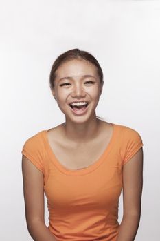 Portrait of teenage girl smiling, studio shot
