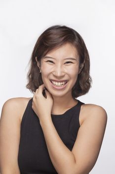 Smiling and happy young woman, portrait, studio shot