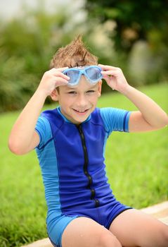 cute kid with goggles and wetsuit in summer