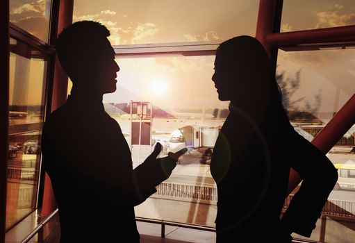 Two business people talking in the airport, Silhouette