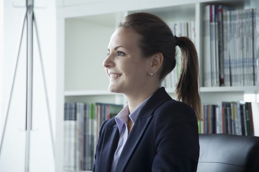 Young businesswoman smiling in the office during a business meeting